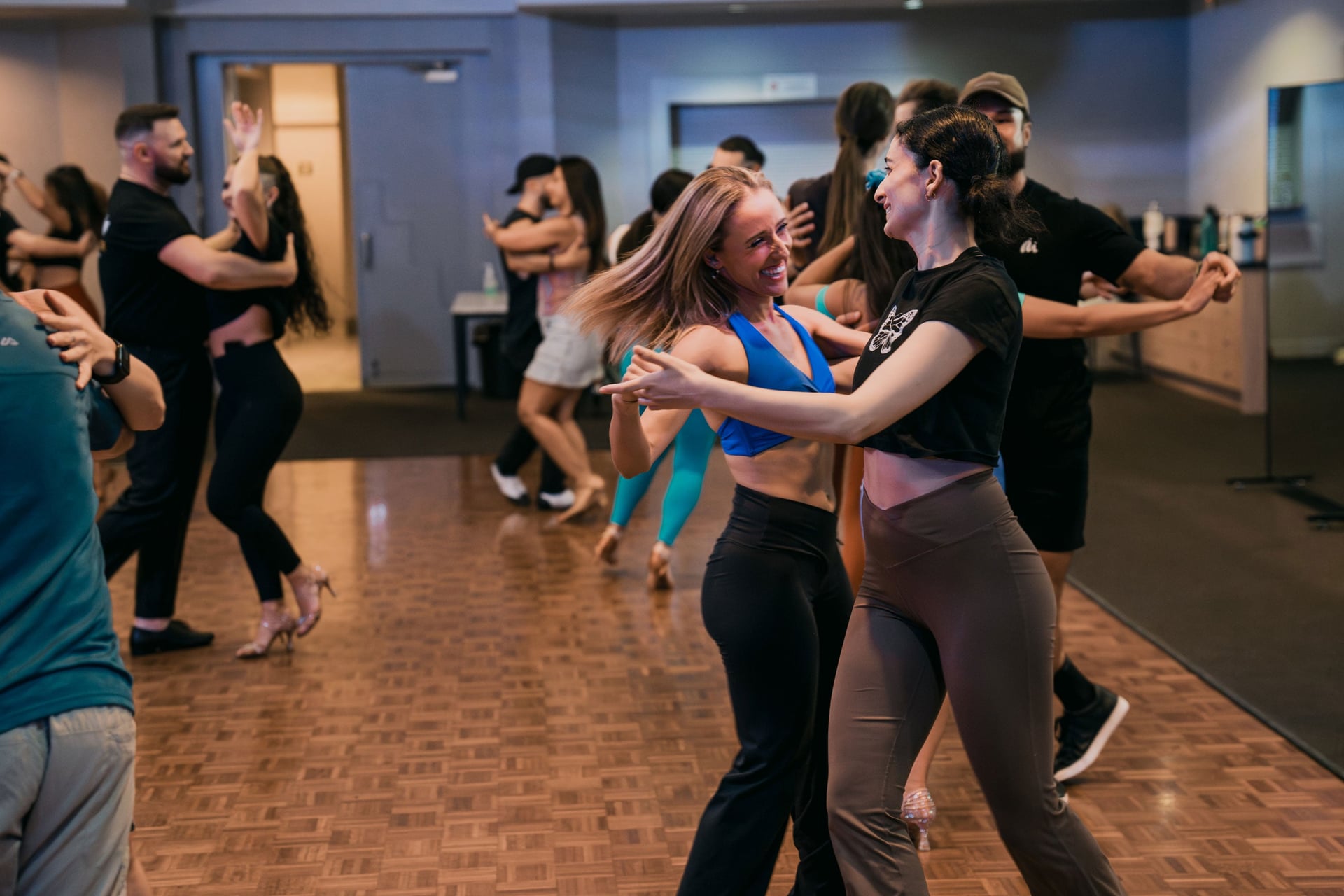 Two girls dancing partnerwork in a salsa class at LocoMojo